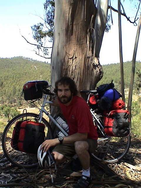 A rest in the hills of Portugal with the loaded bike.  This was after dumping a bunch of gear in Seisembra days earlier.  (7/02/04)