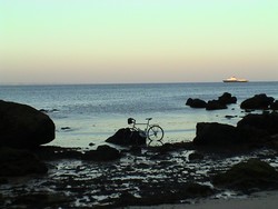 Ah, yes.  The ceremonial dipping of the tires in the Atlantic.  This ended up clogging my brakes and chain with sand and seaweed, but I think it was worth it.  And so it begins.  (7/02/04)