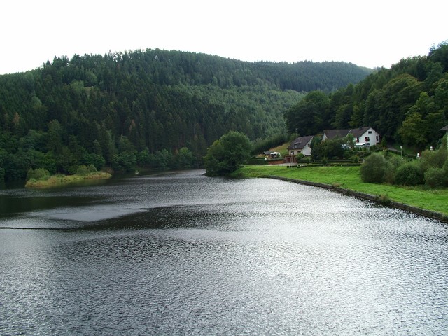 On the first day back on the road I cycled through the Eifel nature reserve in western Germany en route to the Belgian border, where I caught views of lakes and rolling hills along the manure-dotted lanes.  Lunch this day was a malodorous affair; I mistakenly sat across from a greasy-faced and putrifying human wreck and his bandaged sidekick at a Turkish falafal establishment and tried to breath through my mouth while choking down my pita.  Later in the afternoon I reached Einruhr and stopped to stare into the darkening lake surrounded by hillsides covered in pine.  As I approached the Belgian Ardennes the weather was wildly fluctuating between sunny, overcast, and torrents of rain.    8/31/04