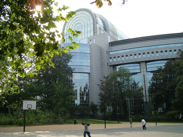 The European Union parliament in Brussels, where nearly all of the EU politcal machinery is located.  Although this is where the business of unified Europe is conducted, the building itself is rather modest and is even fronted by a well-worn basketball courtyard.  There was a pick up game at the time I walked by; the shooting was not too sharp.  (9/04/04)