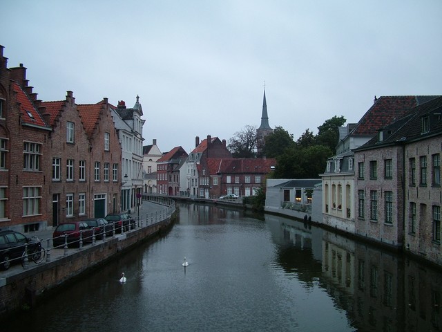 Bruge, Belgium is a former medieval metropolis that was frozen in time when the waterway that connected it to the Flanders seaside silted up in the late fifteenth and early sixteenth century - this caused an exodus of the population that at the time had exceeded London.  It was nice walking around the city in the early morning when the streets were empty and the canals were calm enough to reflect the buildings.  You can see two swans making their way down the canal.  The city is exceptionally well preserved, and unlike other medieval towns filled with crumblies, Bruge is full of intact buildings that appear freshly built.  I bought a museum pass, and feeling the need to maximize the value of the ticket, made the mistake of running through four musuems in one day.  My favorite was a wealthy merchant's house adjoining an enormous cathedral.  One of the mansion's higher level rooms had a window that actually connected to the interior of the cathedral and looked down from a height into the cavernous cathedral - the family could attend church services in the privacy of their home while the kids played or what have you.  The museum collections and exhibits were generally rather small, but still I think I am burnt on museums for the time being.  (9/07/04)