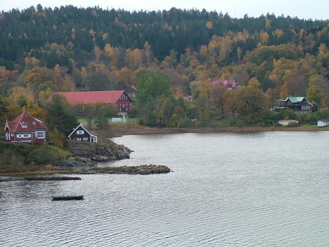 Sweden is all-natural nature.  This is a picture of the western fjords, again with those barnyard red houses, grey skies and yellowing trees.  I stopped at a grocery store nearby and heard the sing song cadence of the Swedish chef�s language being spoken all around me, taking me back to days of the Muppet Show.  Whatever happened to quality children's programming anyway?  (10-19-04)