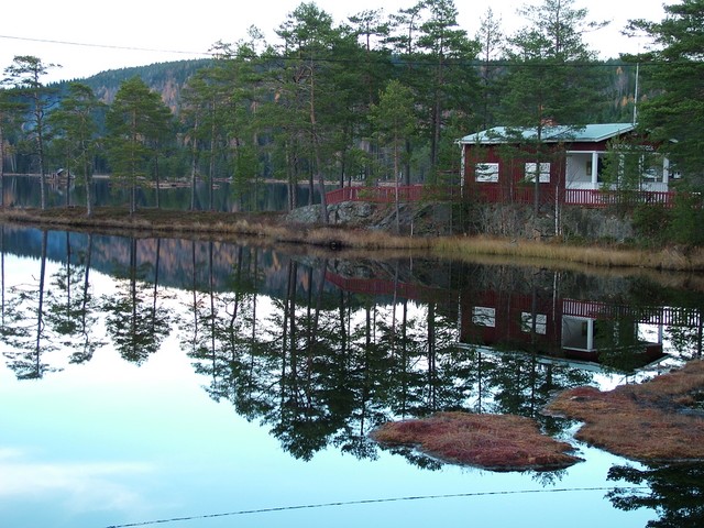 After Oslo it was another five day journey eastward to the next Scandanavian capital, Stockholm.  This took me through Swedish lake land, past one mirror flat lake after another.  And that is not an exaggeration - I have never seen bodies of water that large lie so still.  This is one of many lakes that I passed (again with the red Swedish house), this time in the evening as I was scouting out a camping site.