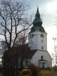 (INTRODUCTORY DISCLAIMER FOR NEW INSTALLMENT:  Alright, I have a lot of catching up to do on the photos, so please ignore any typos, etc.  I am in a Finnish public library with one hour to get all this stuff uploaded, so I am trying to hurry on the keyboard.)  This is a church in Hudiksvall, Sweden, on the eastern Swedish coast as I was making my way up toward Finland from Stockholm.  I thought it looked cool because of the bulbous steeple, which looked almost like the Russian onion bulb steeples, but not quite.  Most Swedish steeples are really steep, like the one in the next picture, so this was something different.  I passed this church after staying a couple of days earlier in G�vle, a university town on the coast.  I stayed in a hostel there where I became the celebrity of the evening when the receptionist spread word that an American was riding his bicycle north (everyone else there was Swedish).  The town had a lot of restaraunts that advertised their American qualities, i.e. "Real American Pizza, Real American Burgers," etc.  Our culinary hegemony is nearly complete when Europeans are advertising "Real American pizza."  (11-1-04)