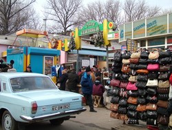Moldova is full of outdoor markets selling just about anything that you might want to buy.  This is where I had earlier picked up a lovely plastic suitcase (well, actually a woven plastic bag with handles) in which to store all my panniers for the flight to Germany (for $2.50!).  I spent most of today cleaning four countries' worth of grime off of my bike and oiling down parts that had developed a bit of rust during the week away.  The parking lot where I worked on the bike was full of barking and play-biting stray Chisinau puppies that the lot attendants would feed.  (1-8-05)