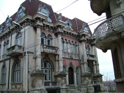 Constanta, Romania's second largest city, was supposed to be "plagued with street hustlers and thieves," but they must have been on winter vacation (like much of the Black Sea coast) when I arrived.  The hotels in the old town near the port were crumbling with giant padlocks on the doors.  A family across from one of the hotels offered me a room which was quite nice (although the air in the unheated house was so cold you could see your breath).  The old guy kept on trying to get me to sample his moonshine of some sort that he kept in an old plastic coke bottle on the table, and I finally relented - wooooo, firey!  The old town looked like it was bombed out, but it was economic ruin rather than warfare - houses with windows smashed in and laundry drying inside wintry squats.  One thing that was really sad in Romania was the stray dog situation.  There were so many wild dogs running around the cities and countryside trying to make it - and a lot of them were not succeeding. This building was at the end of the block where I stayed - obviously a part of town that had one day been pretty ritzy, but was now in decay.  (1-16-05)