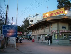 I am really glad that I decided to pay Cyprus a visit, and particularly right now.  For the first time since the 1974 UN brokered ceasefire, when the Green Line and UN buffer zone was gouged in barbwire and watch towers across Cyprus, dividing the country between the Turkish occupied north and the Greek south, you can now visit both sides of the Line.  In spite of this new opening of the borders the political situation is still pretty heavy.  I have to confess I am not entirely clear or educated on the issues, but from what I have been able to gather, the Turkish side's position seems to be that they have no real interest in ending the division of the country and removing Turkish troops.  Although the "Turkish Republic of Northern Cyprus" has never been an internationally recognized country, the north is pretty adamant that it wants the "Republic" to continue in perpetuity (as you can see here).  This was the border post in the divided capital city Lefkosia/Lefkosa.  On the southern side of the Green Line the Greek Cypriots have their own billboards as well.  There are signs showing Greek Cypriots who have been killed by Turkish soldiers, and banners spelling out the demand that the Turkish military occupation end.  To the Greeks there is only one Cyprus, and the Turkish army is an occupying force.  In the middle of the Green Line is the UN buffer zone, where you walk for several hundred meters of land where buildings, houses and storefronts of the capital city that were caught in between the two sides are now in three decades of decay.  But it was nice to see the movement of people back and forth across the island which has been divided for so long.  (3/4/05)