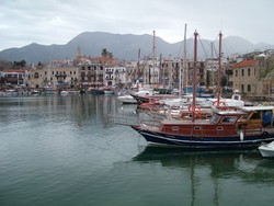 I coasted into Tasucu (where the Turkish ferries run to Cyprus) late at night and really liked the place even though I was there for less than 24 hours.  In the morning I bought a fast ferry ticket, which led to a Twilight Zone journey to Cyprus.  The last time I took a fast ferry was from Jordan back to Egypt, and the waters were not too bad.  I only remember one passenger getting sick then.  The ride to Cyprus was a totally different story.  The seas were really choppy and our fearless captain kept the engines at full steam ahead.  All the passengers were locked in below with the resulting buildup of stale air and heat.  After our ship had been bouncing around for a bit they started passing out puke bags to all the passengers, which were put to good use judging by all the retching noises around me.  The amount of suffering that was taking place in that cabin all in the name of saving a couple of hours was remarkable.  I saw one guy lying in the aisle sweating profusely with the ralph bag in hand, and the woman next to me had her face in the bag for the last half hour of the trip.  It took every ounce of concentration to keep my breakfast down - I might have been better off just giving in.  But I was too burly for that. Did I hear some guffaws?  Well anyway, I was really glad to reach the harbor at Girne (pictured above), and I will definitely be taking the slow ferry back.  I found out when I was cycling into town that they drive on the wrong side of the road here (a result of the U.K.'s involvement in the island's history).  It was the first time on the trip (actually in my life) that I cycled in the left lane.  (3/3/05)