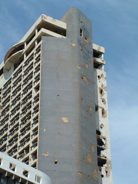 Although the 17-year civil war between the Christian and Muslim militias in Lebanon ended in the early 90's, there is still evidence of the ferocity of the fighting in the form of bullet-riddled and bombed out buildings throughout the country.  The downtown Holiday Inn in Beirut was spanking new at the commencement of the fighting in the mid-70's, and was a magnet for bullets and explosives due to all the snipers who liked to take up positions here.  It stands in sharp contrast next to two of the swankiest hotels in town, but is not the only example of the new building boom sharing space with casualties of the war.  (3/29/05)