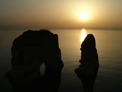 I think that this is what all sunsets looked like in the 1970's in terms of the color scheme.  At least it's been a while since I've seen a golden brown sunset.  It made me nostalgic for Niel Young - pre-Crazy Horse, that is.  This was taken from the Corniche in front of Beirut's landmark Pigeon Rocks.  The Corniche is an active promenade full of Lebanese jogging in track suits, couples out for the sea views, or dogs out for bathroom breaks.  (3/30/05)