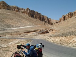 Almost all of my travels in Syria (the second time) have led me through deserts, the more interesting of which were at higher altitudes.  This photo was taken just outside of Maloula when I was still at a pretty decent altitude.  On the desert floor it was nothing but a flat sandbox extending to the horizon, with the exception of one day where I went through the Badlands of Syria.  The day of riding after Maloula to Homs was one of the best of the trip with gorgeous mountain and desert scenery and a tailwind that was the stuff of legends.  I was pushed HARD by those winds down the neverending grade to the Orontes plains with shoulders as broad and smooth as a boulevard, and spent most of the ride above 50 km/h, and even broke the speed record that had been set seasons ago in Spain (by a slight .6 km/h), so that it now stands at an even 79 km/h.  What was key in allowing these speeds was having the descent carry down roads straight as a city grid - no twists or turns that required braking.  Still have not hit the triple-digit ride - that may never come.  (4/7/05)