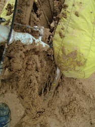 But another 20 km down the road, the pureed track of mud that some optimist had marked as a road on my map turned into what I can only describe as a complete and utter quagmire.  The mud was way too soft, and stuck to my tires in inch-thick layers of paste that would then accumulate on my front forks and rear seat stays until the tires would not move anymore.  This required me to scrape and clear the clearance every couple of rotations.  Then the mud started dropping down into the spokes, like frosting on the beater, as you can see in the top of the frame here.  The mud had also fouled my chain and rear cassette so that the gears were popping when I turned the cranks.  I started pushing the bike off the road, hoping that I could cycle on the unchurned ground, but that was even worse in terms of the mud factor.  I walked back to a rig to see if there was any hope of hitting passable road conditions ahead where I could clean the bike an continue on.  But the response was a "nyeto asphalt" the rest of the way.  He indicated that he was waiting for the sun to bake the road dry - an iffy proposition given that the skies were already clouded over for a shower that started about half an hour later.  I asked if there was any possibility of exchanging dollars to som at the border - again, Nyet - the next bank was Nukus.  So basically, I was out of luck, stuck in the gunk.  (6-07-05)
