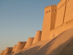 The brief ride from Biruni to Khiva took me past flowering orchards, rank irrigation canals, and alternating hot and cool patches of air.  Once in Khiva, the erstwhile execrably swarthy slave-trading capital of the Silk Road, I met an intrepid elderly British woman travelling alone, who had elected to overnight at the same medressa as I.  She was quite advanced in her years, with a shock of reedy tresses so delicately white as to have been only moments before dipped in pasteurized whole milk.  Her skin was as elegantly lined as a discarded walnut shell, and her lively countenance hinted at a disposition that she held in fragile equipoise - one that was as matronly inclined to doling sweets from her well-provisioned smoked-glass candy jar, as to dispensing justice with her switch should the occasion require it.  Although well into the twilight of her life, the darkening shadows cast by the nearing approach of the grim reaper were not yet capable of extinguishing the coruscating embers of life that glowed fiercly in her eyes, and which, by their residual heat, evidenced a youth that had raged like a bonfire.  (6-12-05)