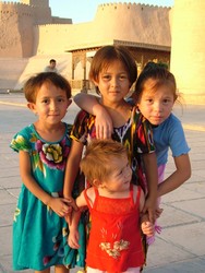 Lads and lasses, should you ever in your travels alight upon Khiva, you will find a quiver of minarets piercing the desert sky with their tapering spires, sparkling blue-tiled medressas by the score, wood pillared mosques by the dozen, a fair sprinkling of travellers from foreign lands with their mouths agape, and in every alley, passageway and square, women and children dressed in garb of every color of light refracted through a prism.  And in the evening, should you be out for a languid stroll in that hour of the night when the sun tires and its ochre rays begin to gild the town with a light coat of luster, with the crenellated walls, keeps and gates seeming to pine for the abstraction of the past, you would have to be suffering from a good deal of indigestion not to join in the nostalgic reverie.  

Um . . . I'll try to finish this ridiculously tortured update tommorrow.(6-12-05)